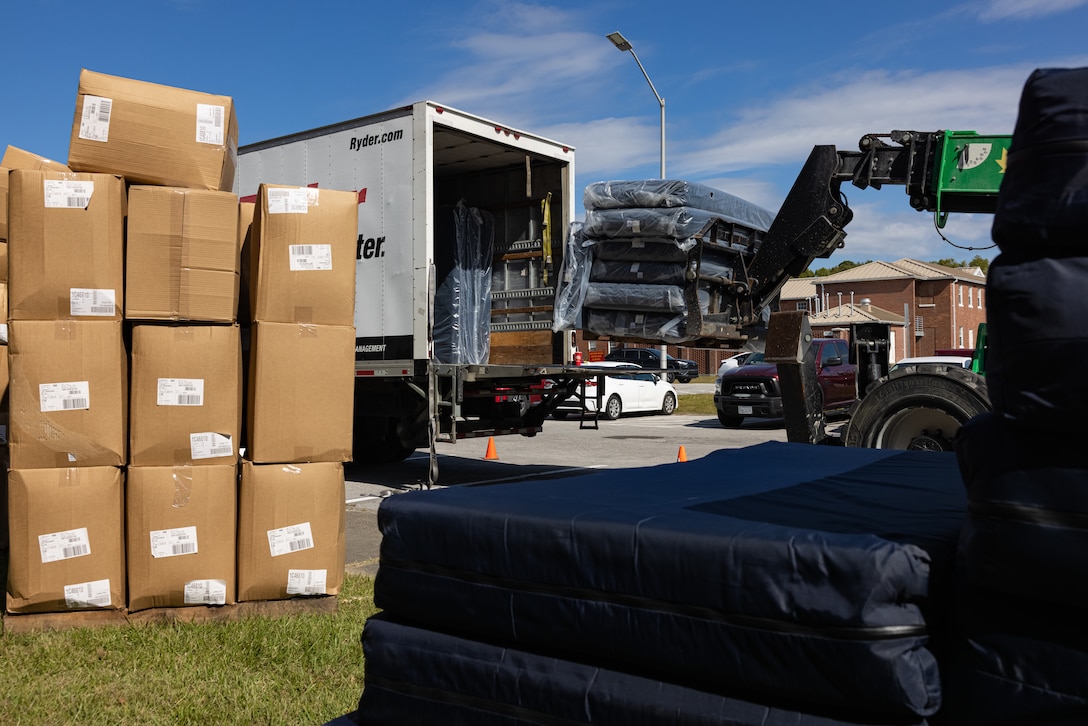 Furniture is staged in front of Building HP-55 on Marine Corps Base Camp Lejeune, North Carolina, Oct. 22, 2024. Marines assigned to H&S Battalion received new mattresses, blinds, and linens as part of an initiative to enhance the quality of life among Marines who live in Bachelor Enlisted Quarters. (U.S. Marine Corps photo by Cpl. Loriann Dauscher)
