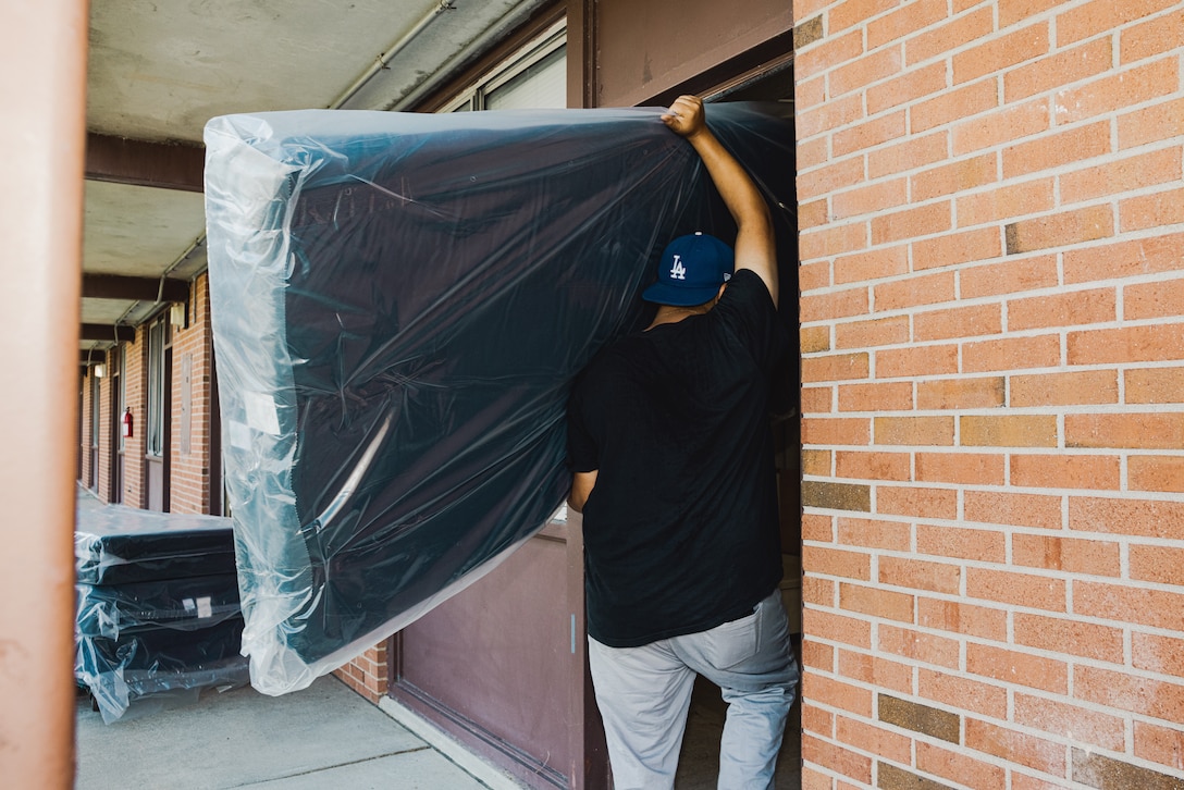 Bryan Chicas, an installer, sourced through ServMart, delivers mattresses into a barracks room in Building HP-55 on Marine Corps Base Camp Lejeune, North Carolina, Oct. 22, 2024. Marines assigned to H&S Battalion received new mattresses, blinds, and linens as part of an initiative to enhance the quality of life among Marines who live in Bachelor Enlisted Quarters. (U.S. Marine Corps photo by Cpl. Loriann Dauscher)