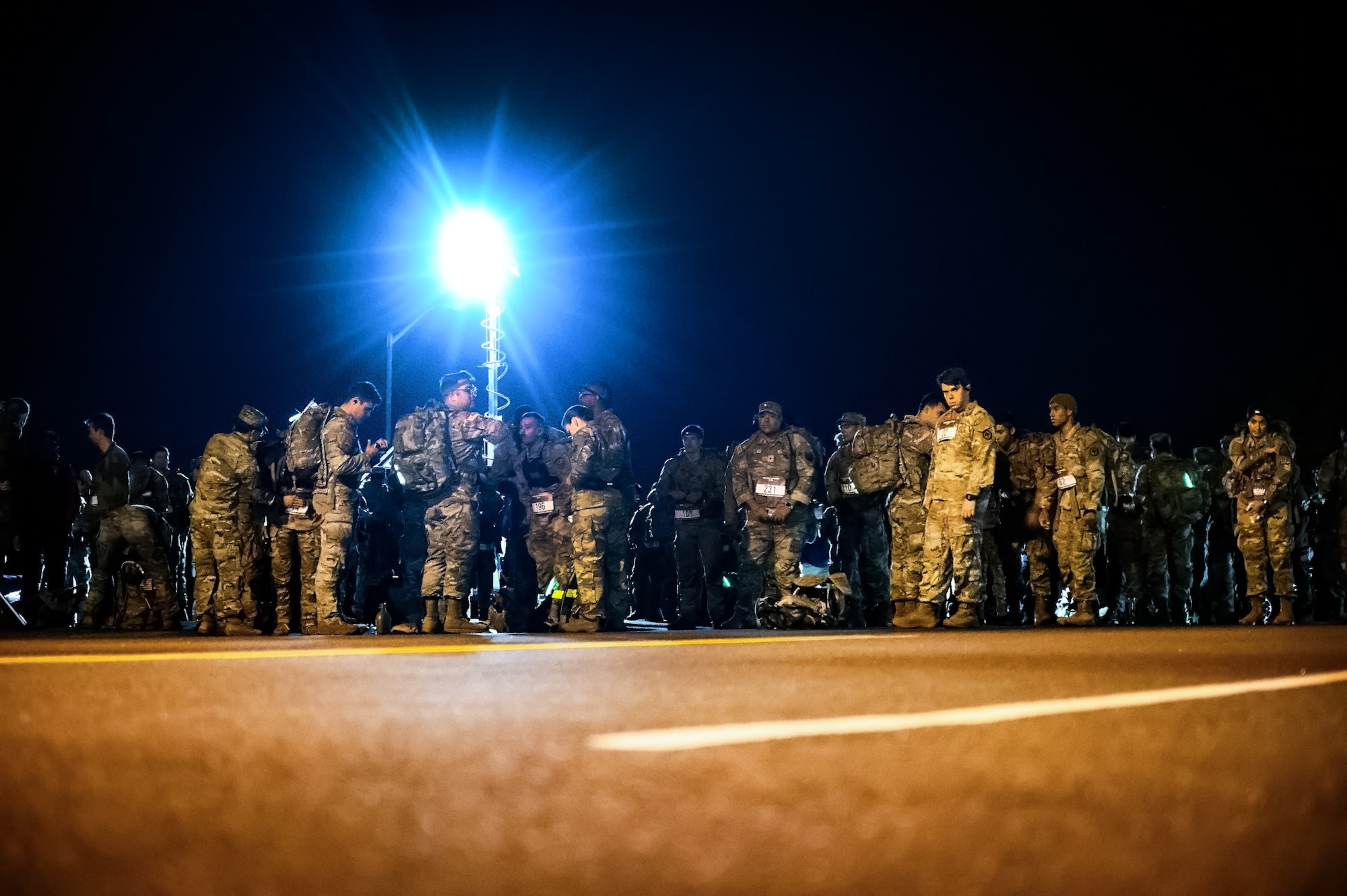 Service members assigned to Joint Base McGuire-Dix-Lakehurst prepare for the Norwegian Foot March at JB MDL, N.J., Oct. 13, 2024. The Norwegian Foot March is a military endurance test where participants march or run an 18.6-mile-long route, carrying a rucksack of 24 lbs. (U.S. Air Force photo by Senior Airman Matt Porter)