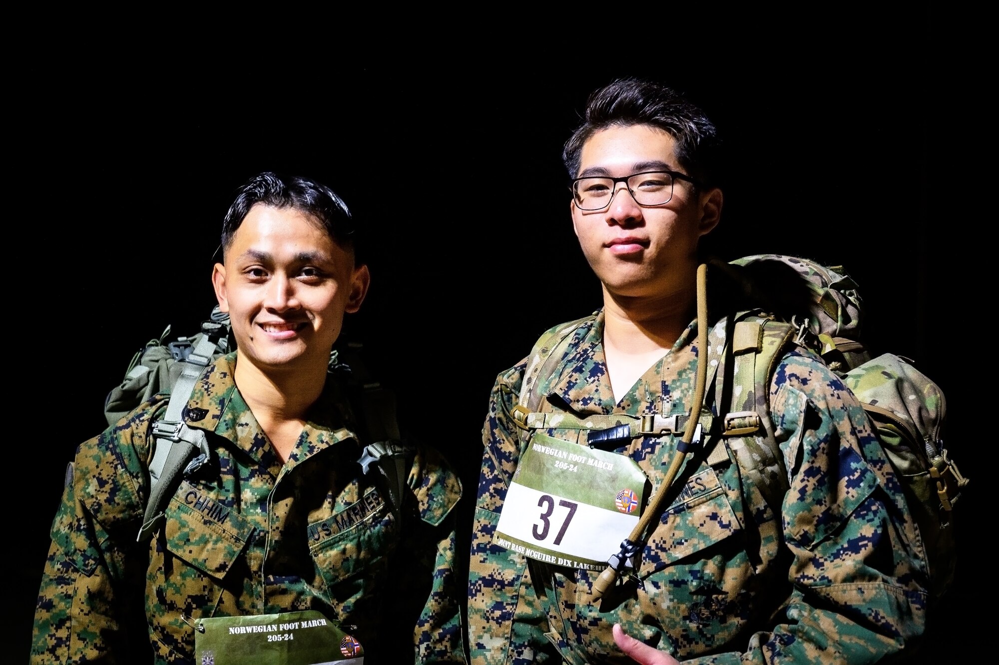 U.S. Marine Corps Staff Sgt. Ian Chhim, 1st Marine Corps District infantry rifleman and U.S. Marine Corps Lance Cpl. Ricky Kai 1st Marine Corps District infantry rifleman, pose for a photo during the Norwegian Foot March at JB MDL, N.J., Oct. 13, 2024. The Norwegian Foot March is a military endurance test where participants march or run an 18.6-mile-long route, carrying a rucksack of 24 lbs. (U.S. Air Force photo by Senior Airman Matt Porter)