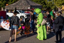 Families of Marines, Sailors and civilians, aboard Marine Corps Recruit Depot San Diego, participate in the MCRD San Diego annual Trunk-or-Treat event at MCRD San Diego, California, Oct. 25, 2024.  The trunk-or-treat event gives the Marines, Sailors, civilians and their families an opportunity to dress up and collect candy in a safe and controlled environment. (U.S. Marine Corps photo by Lance Cpl. Jacob B. Hutchinson)