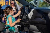 A participant in the in the Marine Corps Recruit Depot San Diego annual Trunk-or-Treat event sits in the front seat of a military police squad car at MCRD San Diego, California, Oct. 25, 2024.  The trunk-or-treat event gives the Marines, Sailors, civilians and their families an opportunity to dress up and collect candy in a safe and controlled environment. (U.S. Marine Corps photo by Lance Cpl. Jacob B. Hutchinson)