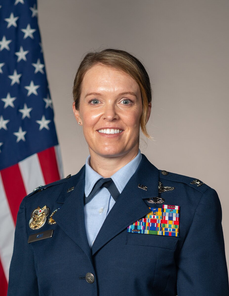 Col Kent standing near the flag for her studio portrait.