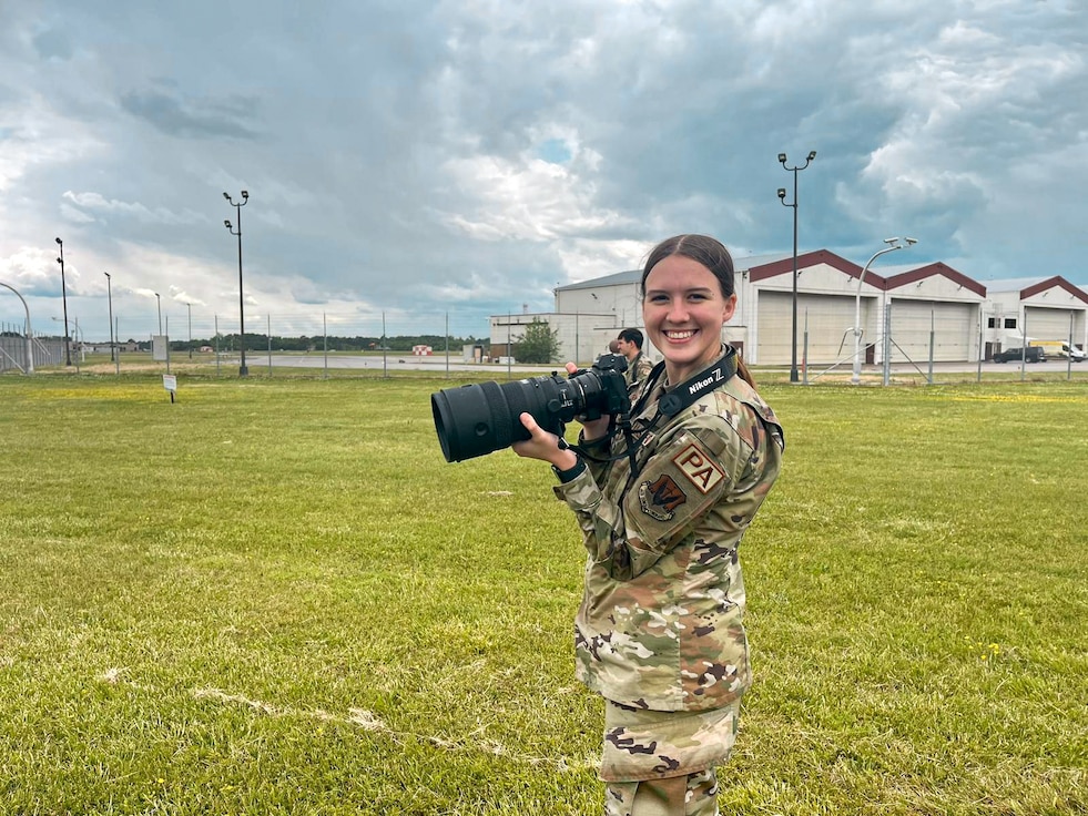 Airman holding a camera.