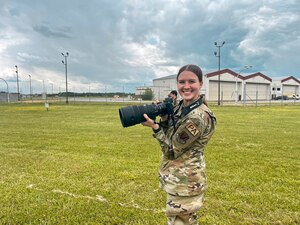 Airman holding a camera.