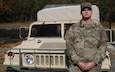 Spc. Andrew Ritter, a 25B Information Technology Specialist with the 360th Civil Affairs Brigade, stands in front of an ammunition truck for a picture at the Pistol Qualification range at Hopkins, South Carolina, November 1, 2024. Ritter who previously was as an active duty 11C, Indirect Fire Infantryman, is now with the Army Reserve. (Photo by U.S. Army Spc. Anthony Till)