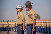 U.S. Marine Corps Capt. Thomas Mccarthy, left, the company commander, and U.S. Marine Corps 1st Sgt. Kelvin E. Carrington, unit senior enlisted leader, both with India Company, 3rd Recruit Training Battalion, stand during a graduation ceremony at Marine Corps Recruit Depot San Diego, California, Oct. 25, 2024. This ceremony marked the end of a 13-week transformation that included training in drill, marksmanship, basic combat skills, and Marine Corps customs and traditions. (U.S. Marine Corps photo by Lance Cpl. Janell B. Alvarez)