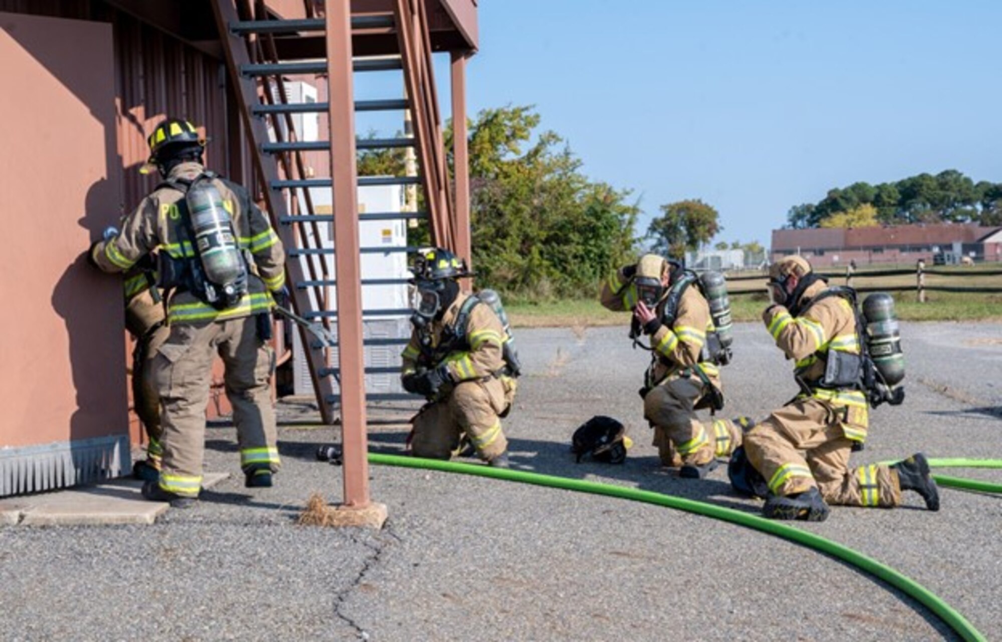 Firefighters prepare to enter burning building in a training event. (U.S. Air Force photo by Airman Donnell Ramsey)