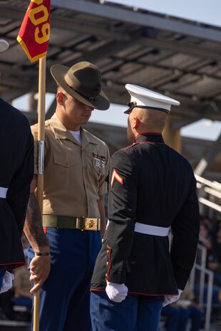 U.S. Marine Corps Sgt. Joseph C. Zerener, right, a drill instructor and Pfc. Crandon Dwyer both with India Company, 3rd Recruit Training Battalion, retire the guidon during a graduation ceremony at Marine Corps Recruit Depot San Diego, California, Oct. 25, 2024. This ceremony marked the end of a 13-week transformation that included training in drill, marksmanship, basic combat skills, and Marine Corps customs and traditions. (U.S. Marine Corps photo by Lance Cpl. Janell B. Alvarez)