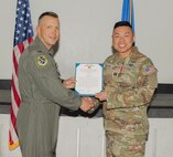 U.S. Air Force Col. Dane J. Gehrmann, commander of the Nevada Test and Training Range (NTTR), presents the Meritorious Service Medal (MSM) to Capt. Jesse Nguyen, acquisition manager assigned to NTTR during a commander’s call at Nellis Air Force Base, Nevada, Oct. 31, 2024.