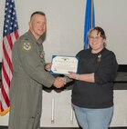 U.S. Air Force Col. Dane J. Gehrmann, commander of the Nevada Test and Training Range (NTTR), presents the Air Force Exemplary Civilian Service award to Emily Chesebrough, a range operations specialist assigned to NTTR, during a commander’s call at Nellis Air Force Base, Nevada, Oct. 31, 2024.