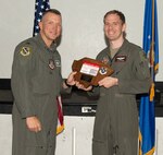 U.S. Air Force Col. Dane J. Gehrmann, left, commander of the Nevada Test and Training Range (NTTR), presents the Field Grade Officer of the Quarter award to Lt. Col. James Carfagno, Director of Operations assigned to the 31st Combat Training Squadron, during a commander’s call at Nellis Air Force Base, Nevada, Oct. 31, 2024.
