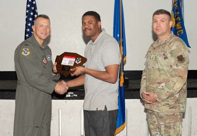 U.S. Air Force Col. Dane J. Gehrmann, left, commander of the Nevada Test and Training Range (NTTR), and Senior Master Sgt. Dennis Kolesnik, right, senior enlisted leader assigned to NTTR, present the Civilian Category I of the Quarter award to Kevin Seals, a unit program coordinator assigned to NTTR during a commander’s call at Nellis Air Force Base, Nevada, Oct. 31, 2024.
