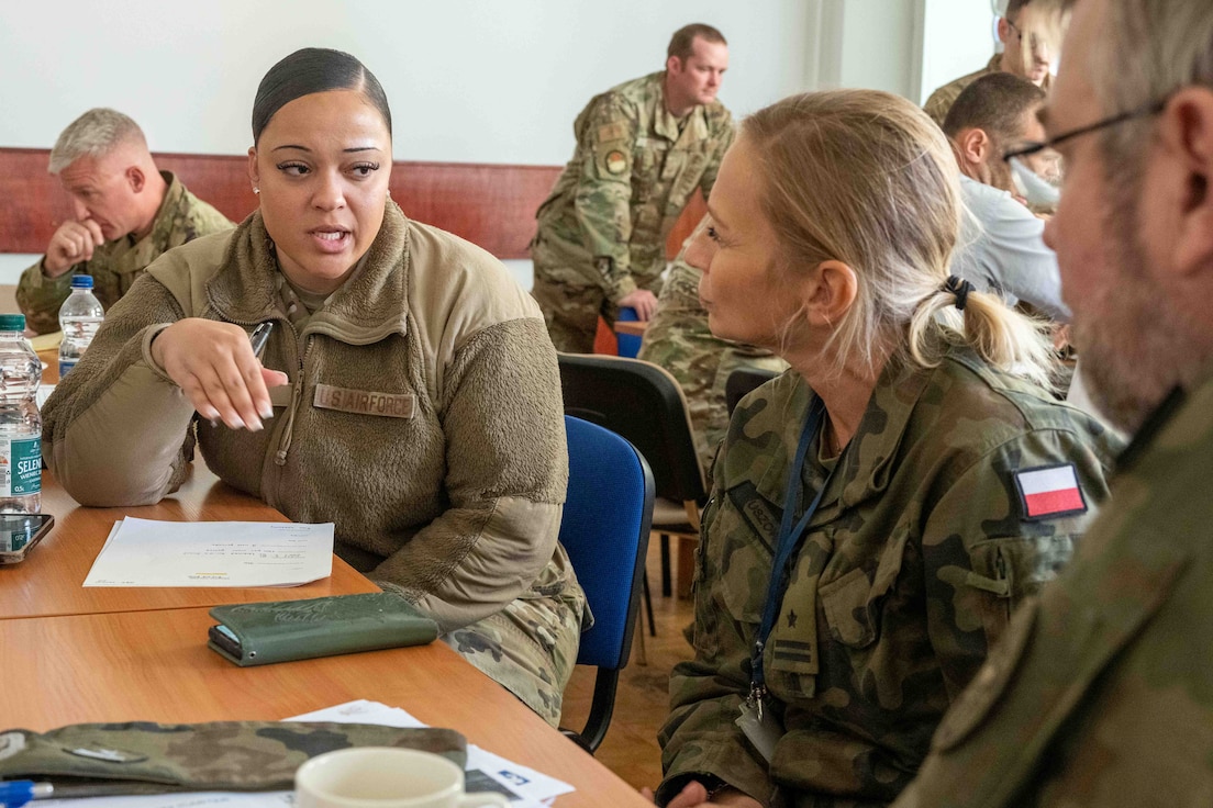 U.S. Master Sgt. Tasia Clark, 126th Force Support Squadron, asks her counterparts about the services available during an Expeditionary Site Survey at Krakow, Poland, Oct. 21, 2024.