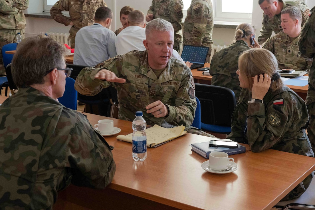 U.S. Air Force Tech. Sgt. Nick Winter, 182nd Airlift Wing, discusses ammo storage capabilities with his Polish counterparts at Krakow, Poland, Oct. 21, 2024.