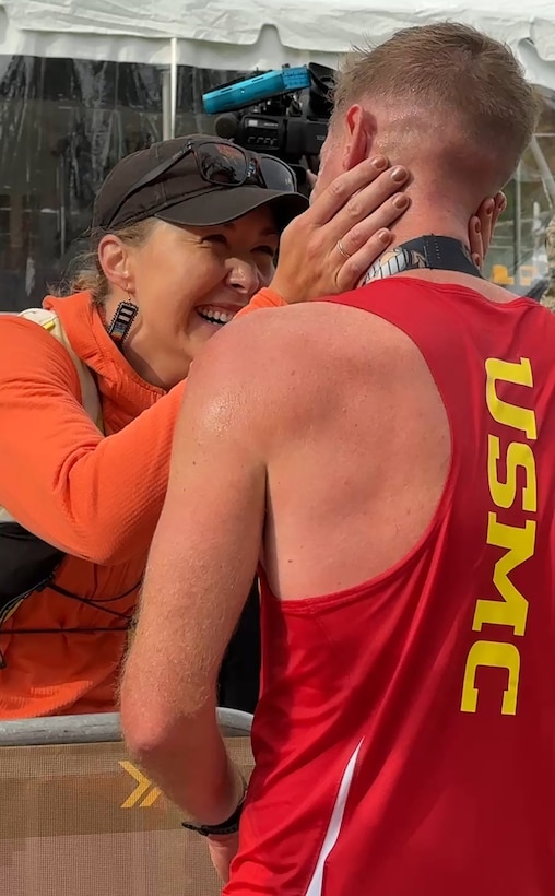 Hope Sweetnam greets congratulates her boyfriend, Marine Maj. Kyle King, Marine Corps Air Ground Combat Center, 29 Palms, California, for winning the 49th Marine Corps Marathon. King was the first active-duty Marine to win the MCM in 2022 in more than 30 years. (U.S. Defense Department photo by Shannon Collins)