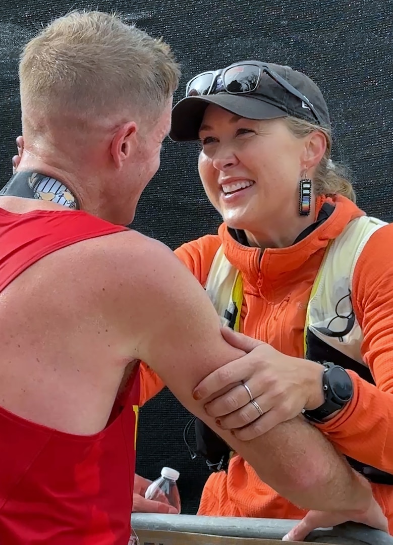 Hope Sweetnam greets congratulates her boyfriend, Marine Maj. Kyle King, Marine Corps Air Ground Combat Center, 29 Palms, California, for winning the 49th Marine Corps Marathon. King was the first active-duty Marine to win the MCM in 2022 in more than 30 years. (U.S. Defense Department photo by Shannon Collins)