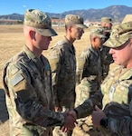 Col. Andy Kiser, right, commander of 2nd Stryker Brigade Combat Team, 4th Infantry Division, Fort Carson, Colorado, congratulates Capt. Kyle Smith, a logistics officer with 4th ID, for receiving an Army Commendation after a National Training Center rotation. (Courtesy photo)