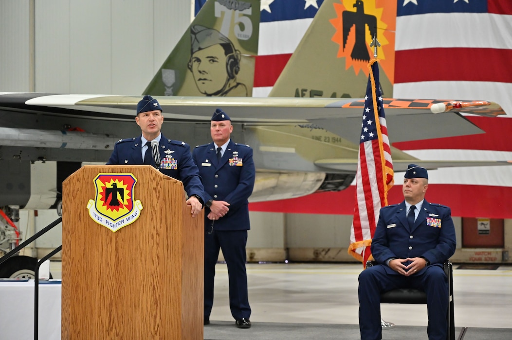 Commander gives a speech behind podium.