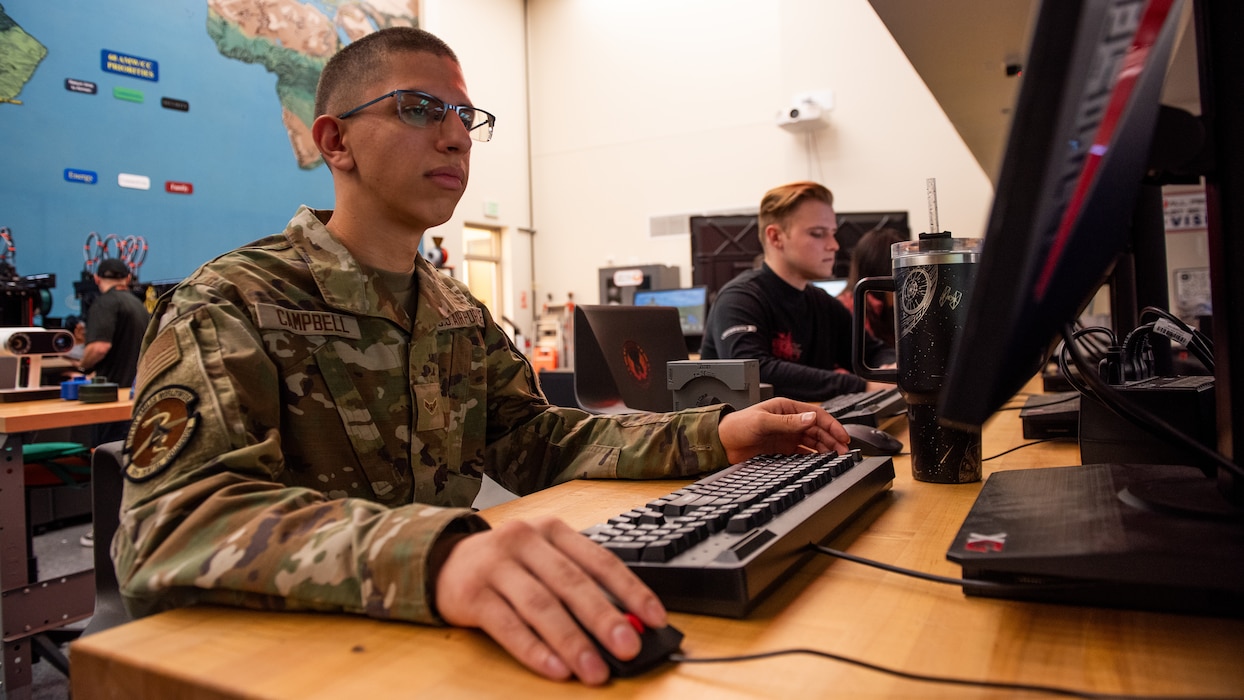 Airmen working on training on computer