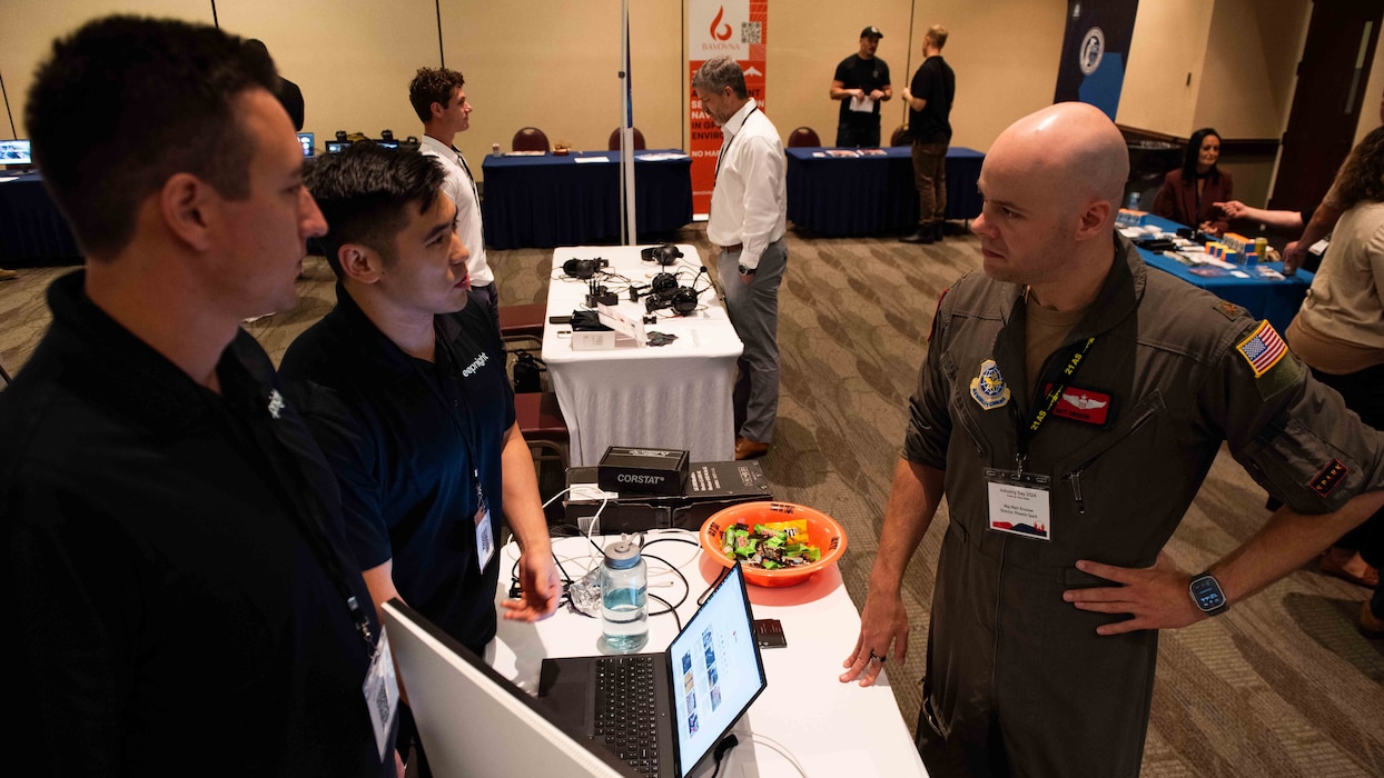 Airmen speaks with industry representatives