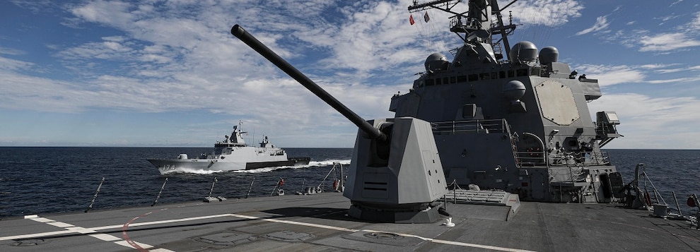 The Arleigh Burke-class guided-missile destroyer USS Dewey (DDG 105), foreground, sails in formation with the Royal Malaysian Navy Kedah-class offshore patrol vessel KD Terengganu (F 174) in the Andaman Sea while participating in Cooperation Afloat Readiness and Training (CARAT) Malaysia, Nov. 1, 2024.