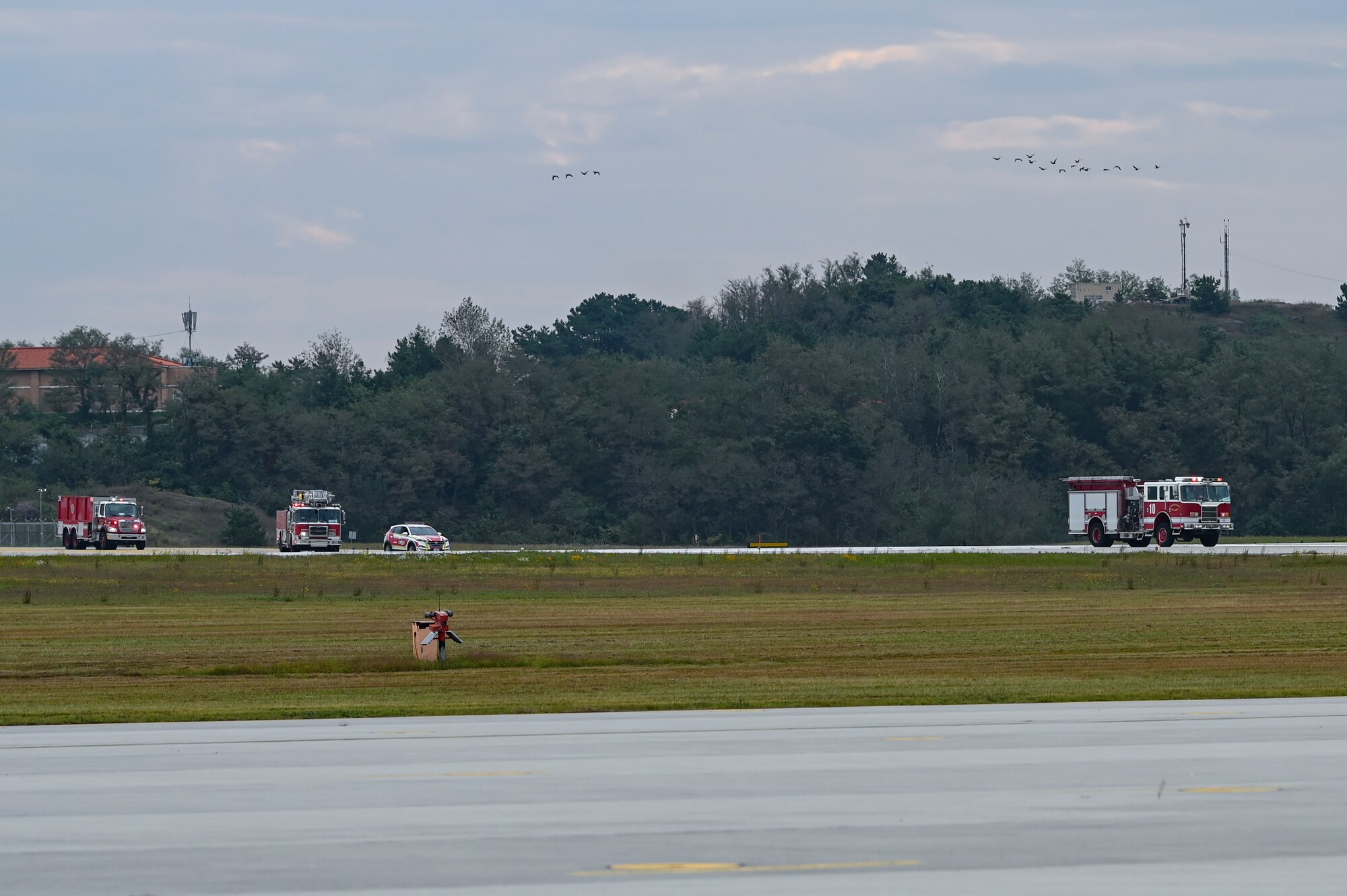 U.S. Air Force fire trucks arrive to a mass accident response exercise.