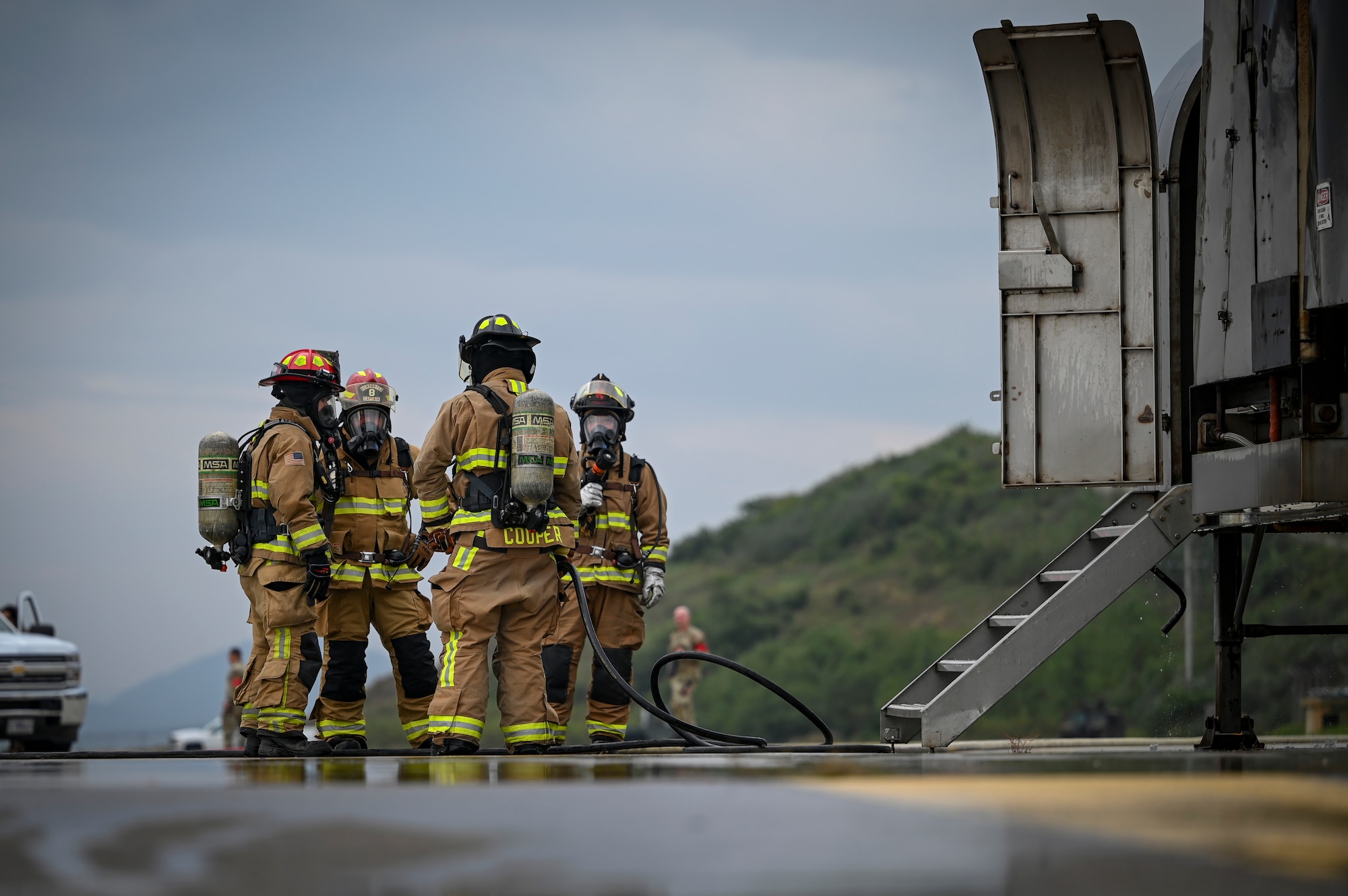 U.S. Air Force firefighters, assigned to the 8th Civil Engineer Squadron, extinguish a fire during a mass accident response exercise.