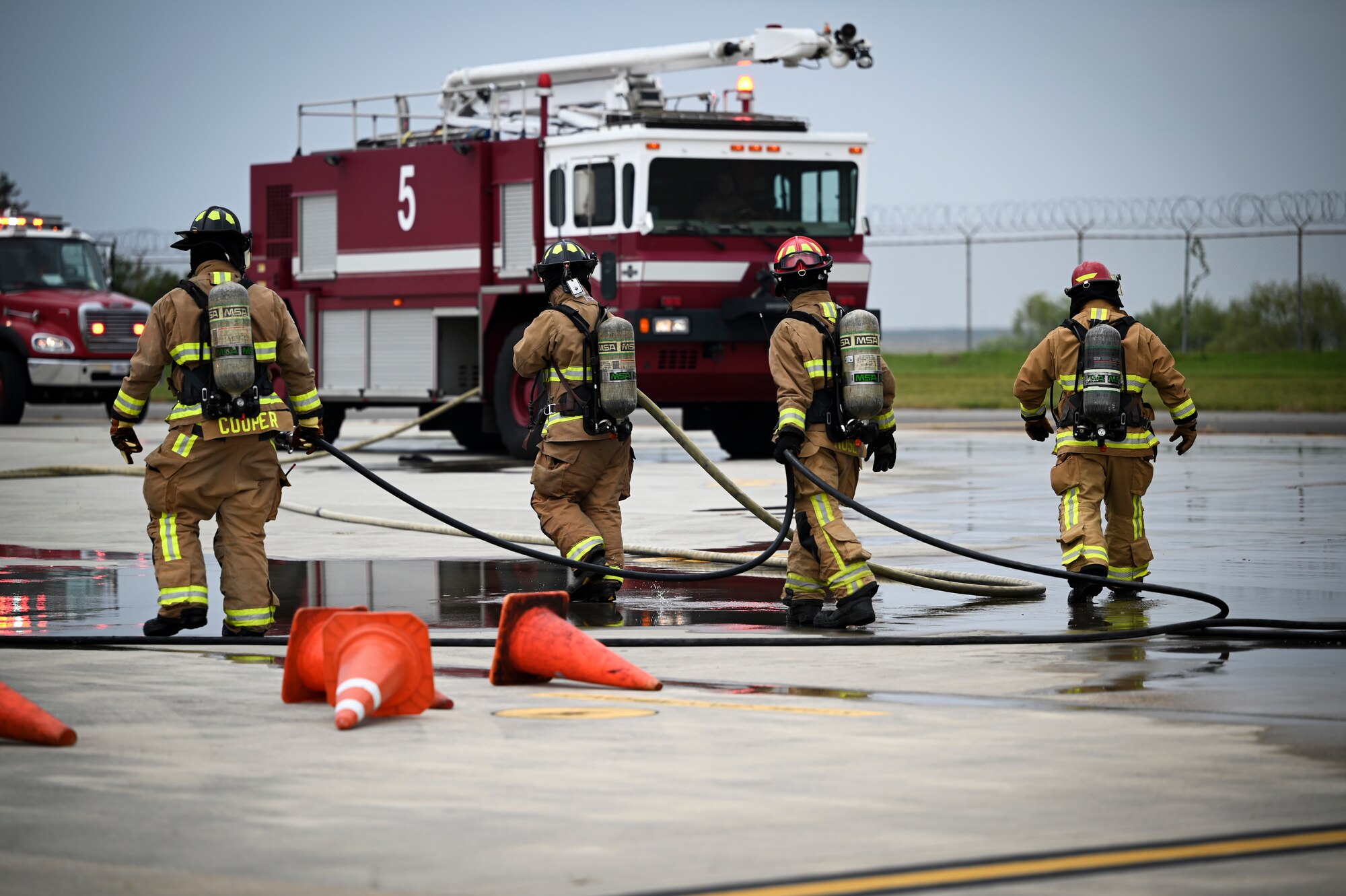 U.S. Air Force firefighters, assigned to the 8th Civil Engineer Squadron, prepare to leave a mass accident response exercise after extinguishing a fire.