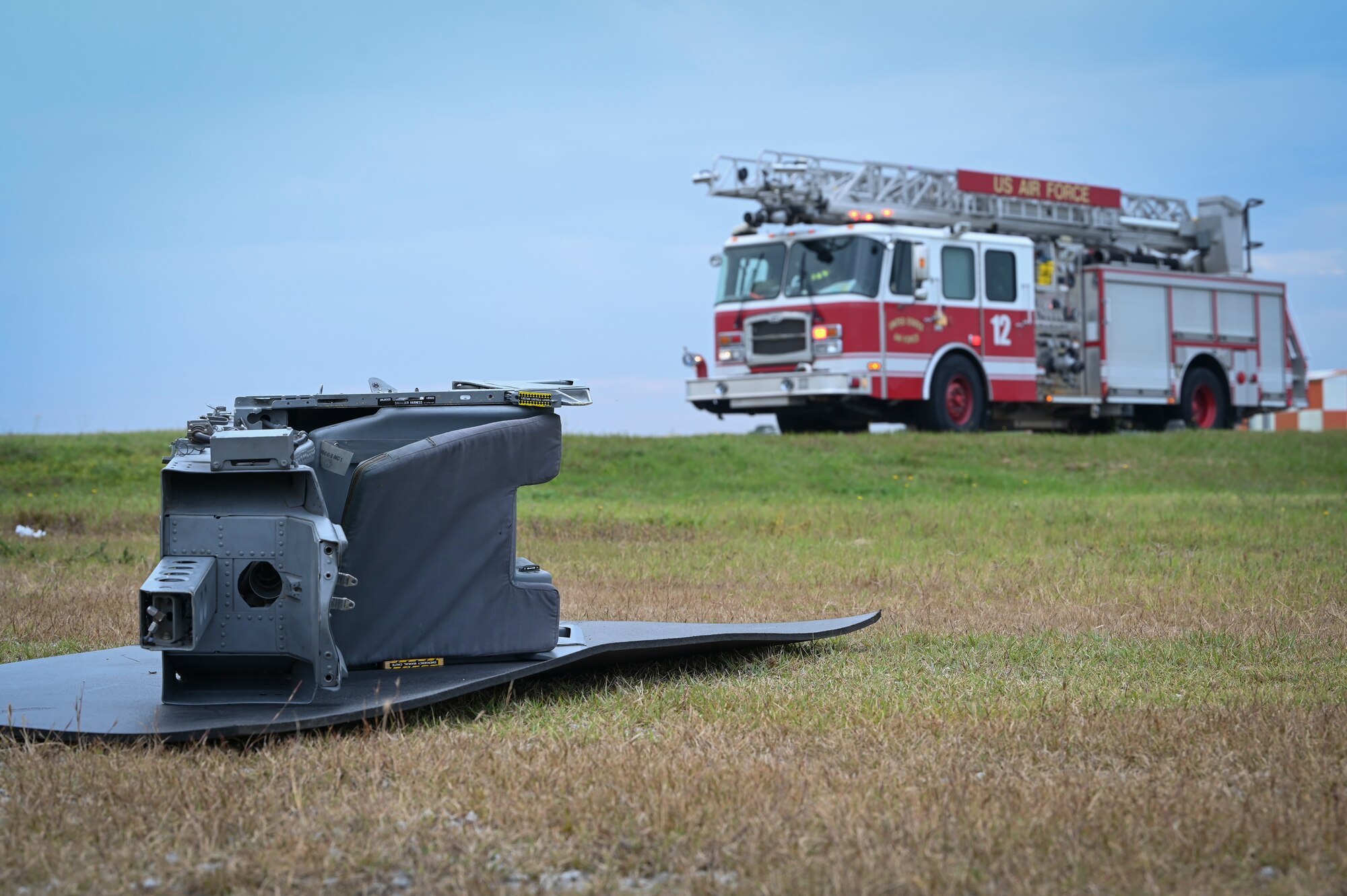 A simulated ejection seat is displayed on the ground during a mass accident response exercise.