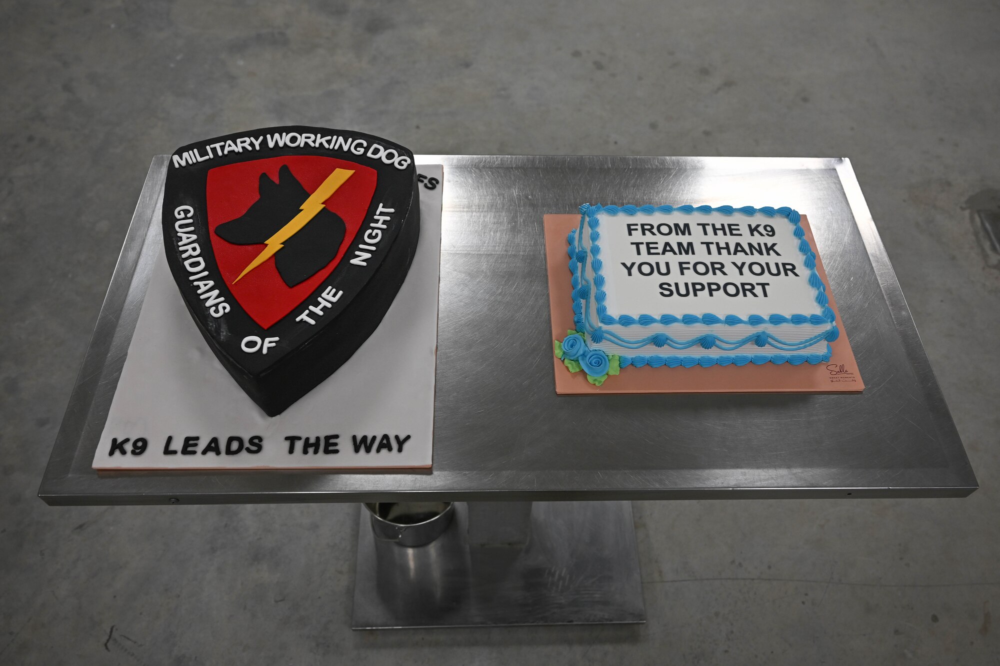 Two decorated cakes sit on a table.