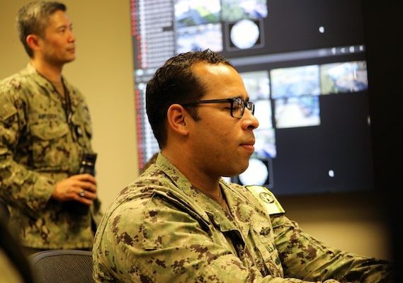 Chief Hospital Corpsman Anthony Abilez, the medical Command Post Exercise (CPX) battle watch chief from Naval Medical Forces Pacific, takes notes and enters data while Cmdr. Noah Apusen, deputy director of NMFP’s Maritime Operations Center, observes during a CPX briefing at Naval Medical Center San Diego, Oct. 31. The three-day CPX, a part of Keen Sword 25, was designed to help sharpen Navy Medicine’s capabilities in command and control, patient movement, and medical logistics. Keen Sword is a biennial, joint and bilateral field-training exercise involving U.S. military and Japan Self-Defense Forces personnel, designed to increase readiness and interoperability while strengthening the U.S.-Japan alliance.