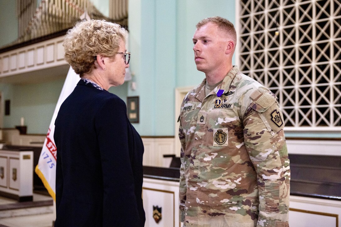 U.S. Rep. Chrissy Houlahan, left, presents a Purple Heart to U.S. Army Sgt. 1st Class Michael Picard, assigned to the Recruiting and Retention Battalion, Pennsylvania Army National Guard, during a ceremony at Valley Forge Military Academy in Wayne, Pennsylvania, Nov. 1, 2024. Picard was recognized for actions he took while deployed to Afghanistan with the Oklahoma National Guard in 2011. (U.S. Army National Guard photo Staff Sgt. Brandon Willis)