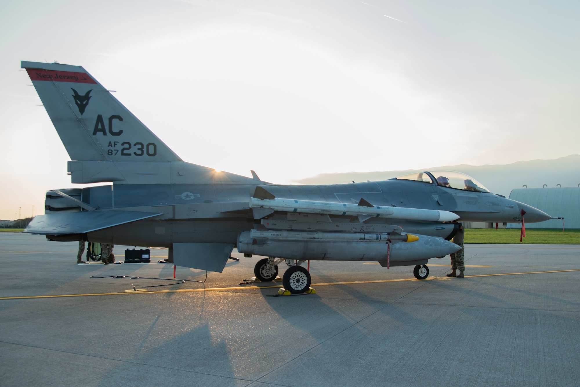 An F-16C fighter sits on display on a flightline.