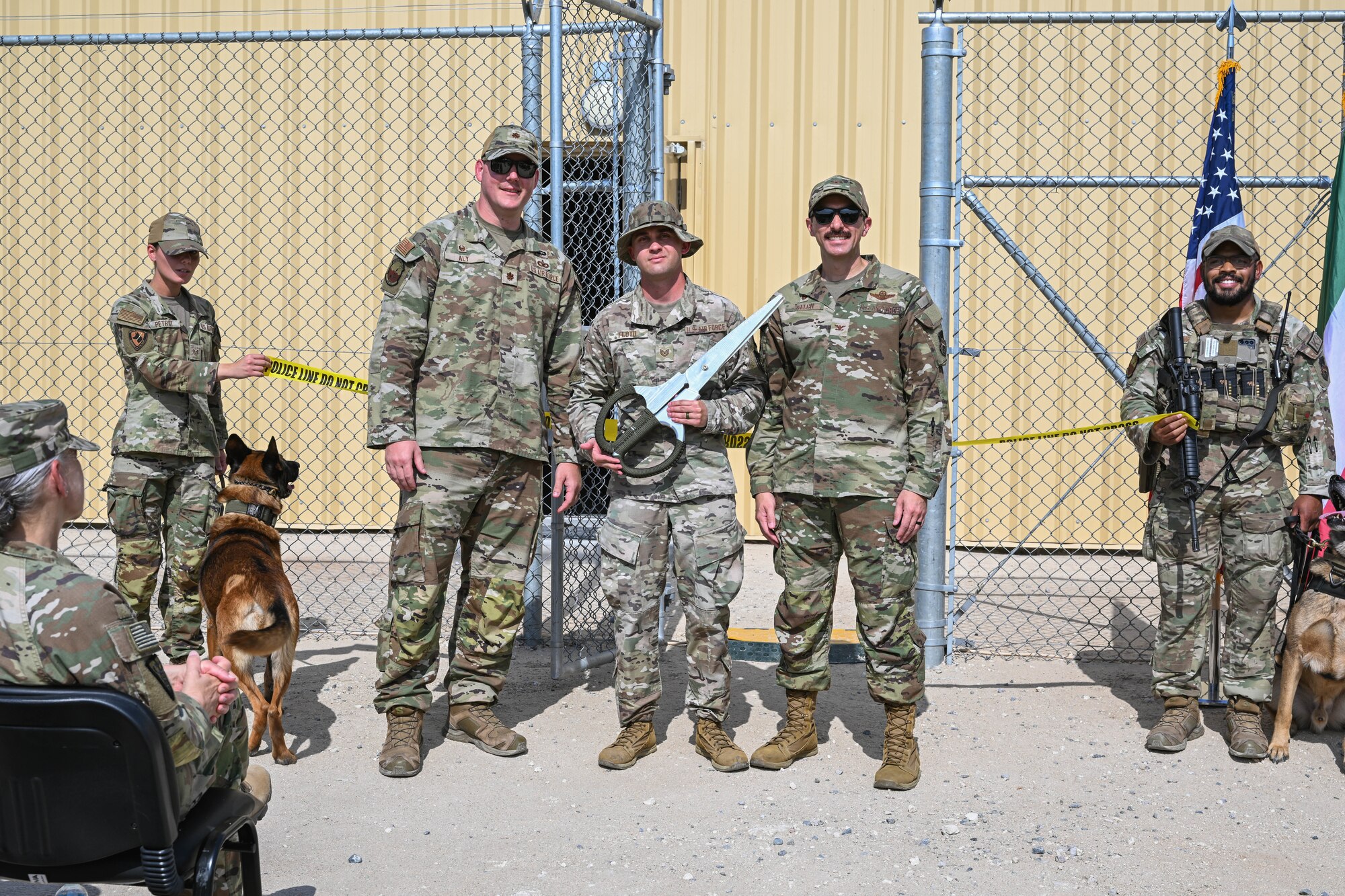 Three men in uniform stand and pose for a photo.