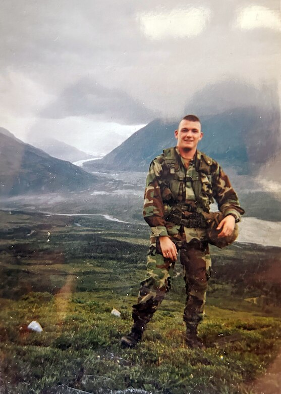 Soldier standing on mountain.