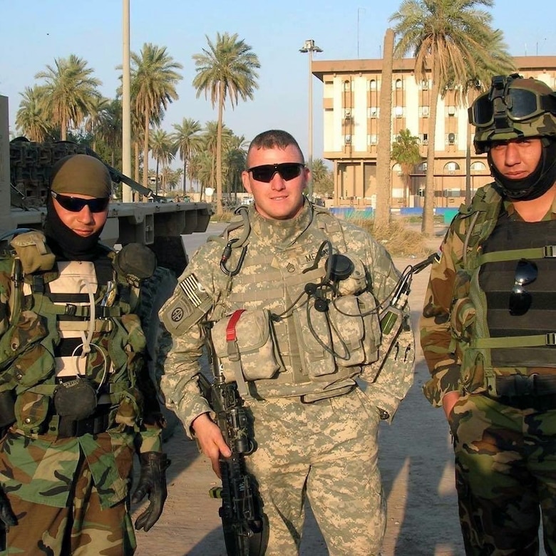 Soldier in desert deployed with other Soldiers.