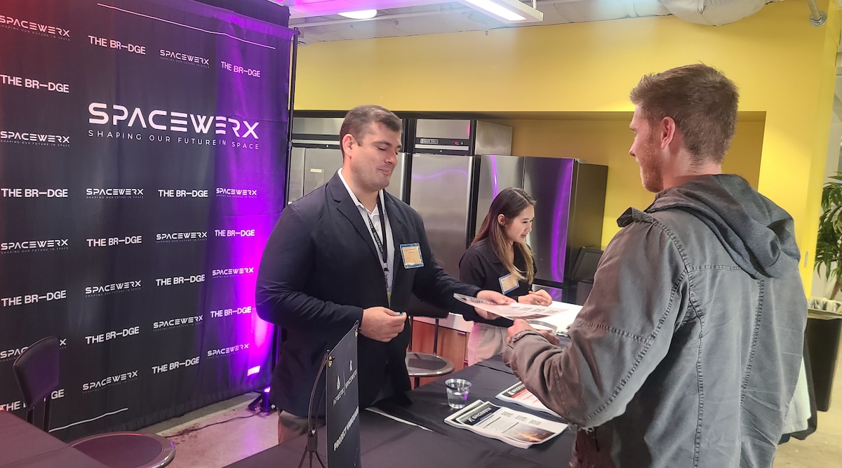 Capt. Jeremy Swaw, left, SpaceWERX Spark lead, engages with industry during the Innovate to Accelerate Expo Day in El Segundo, Calif., Oct. 17, 2024.