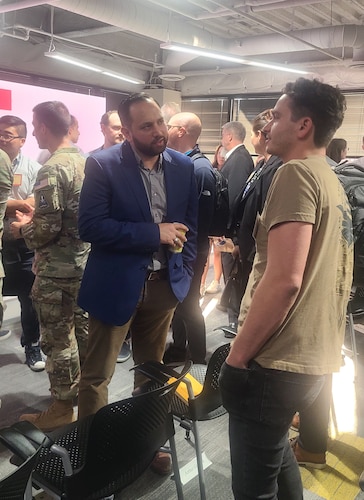 Arthur Grijalva, left, SpaceWERX director, answers questions from industry representatives in between sessions at the Innovate to Accelerate Expo Day in El Segundo, Calif., Oct. 17, 2024.