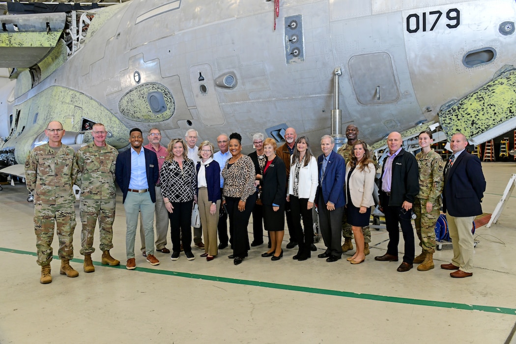 Photo shows group of people in front of aircraft