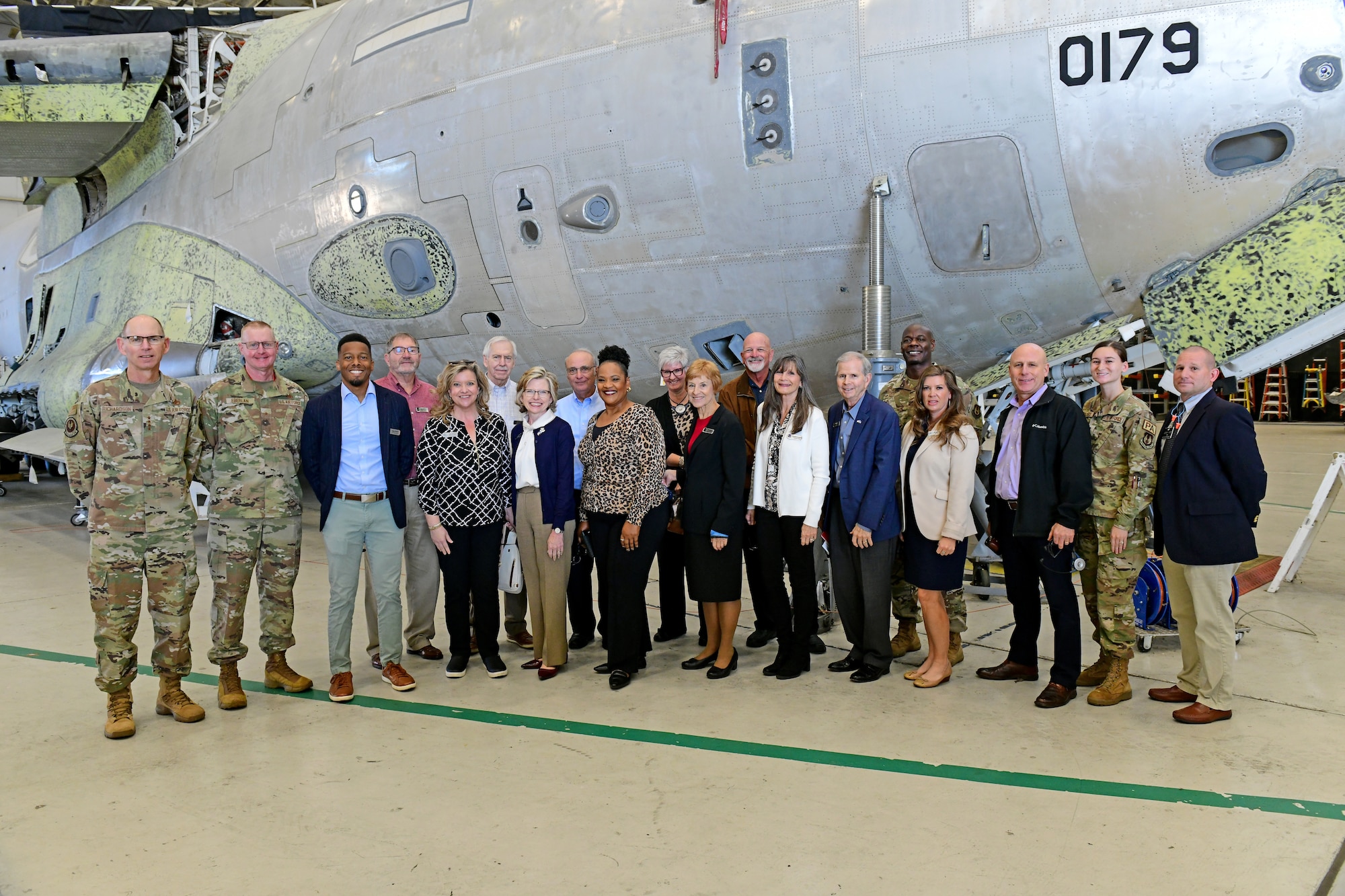 Photo shows group of people in front of aircraft