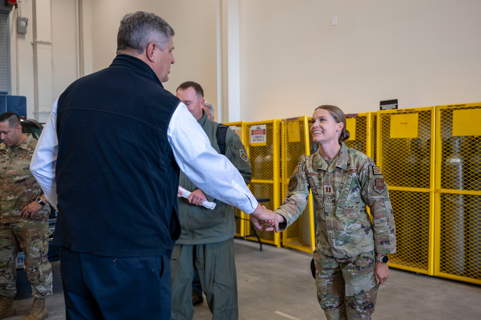 An Airman shakes a mans hand.