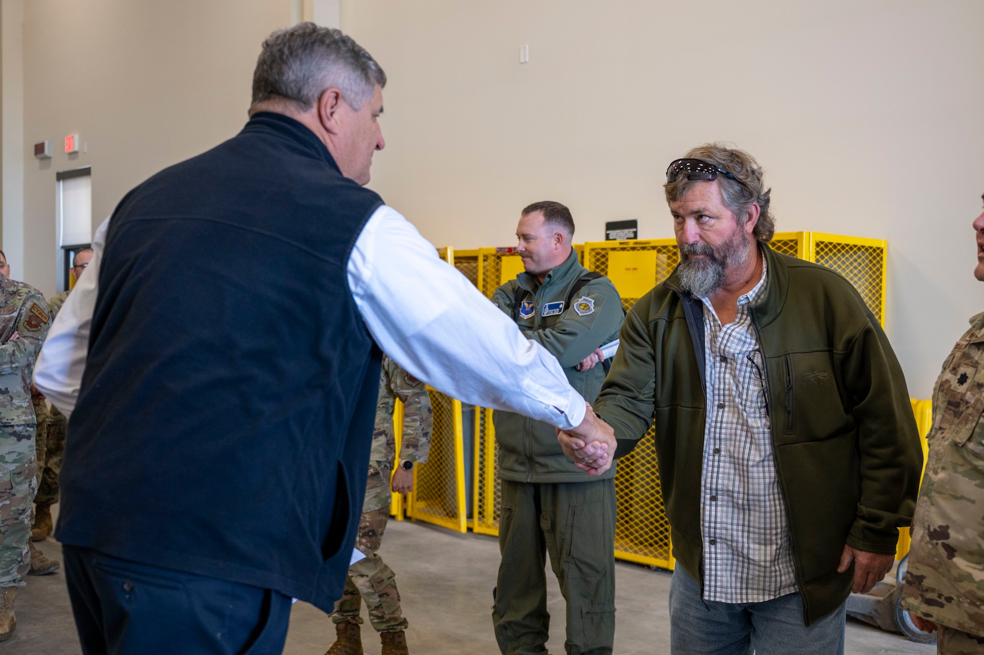 A man shakes another mans hand.
