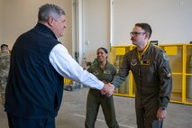 A man shakes an Airmans hand