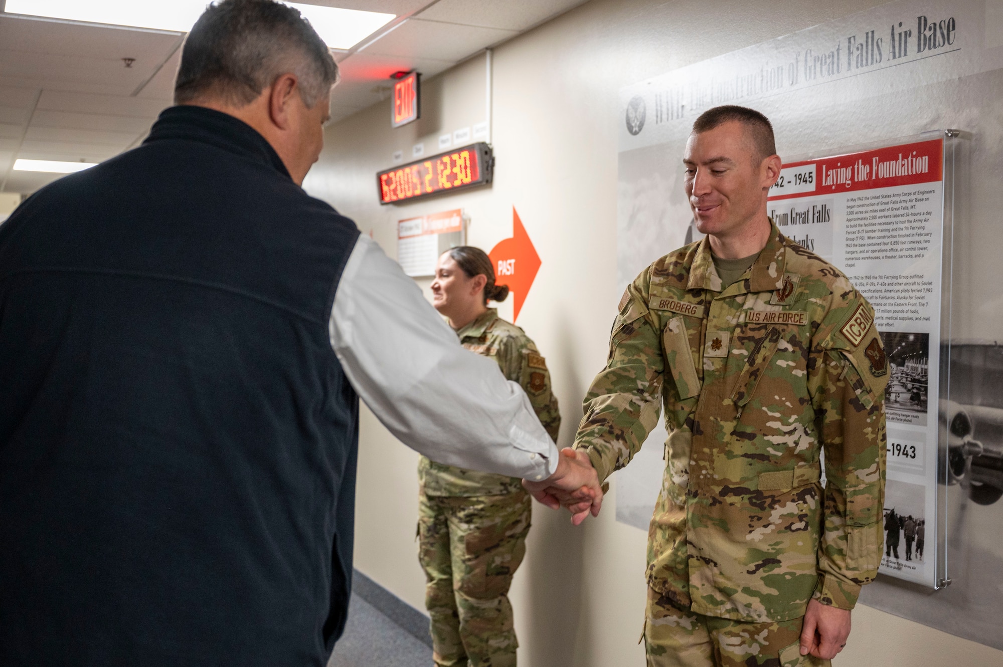 An Airman shakes a mans hand