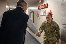 An Airman shakes a mans hand.