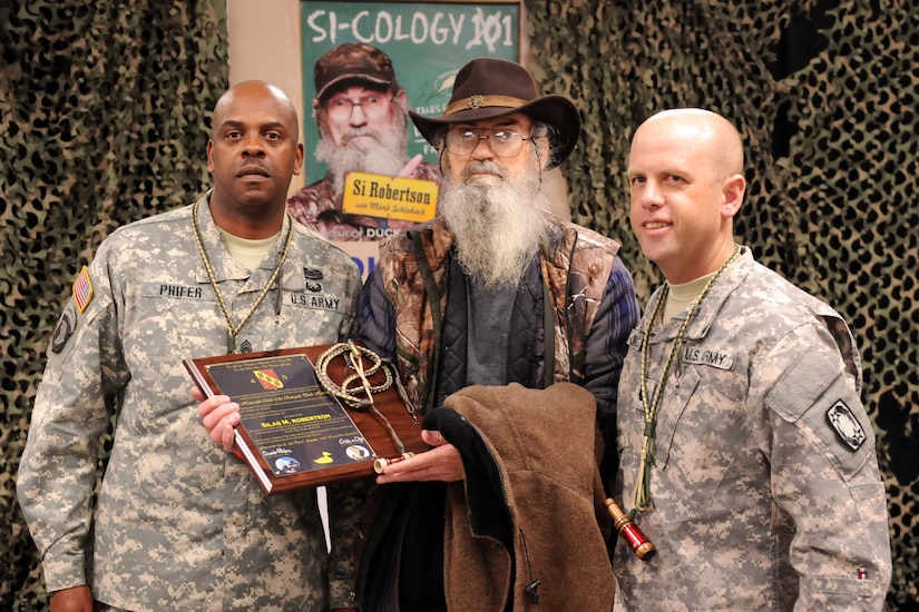 Three men pose for a photo.