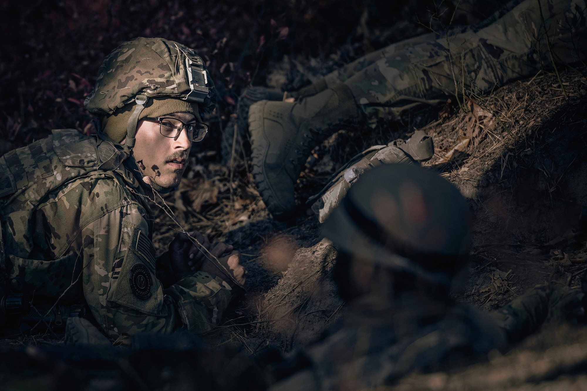 U.S. Air Force Senior Airman Shane Reynolds, 87th Civil Engineer Squadron firefighter, takes cover during a simulated helicopter attack during Operation Honey Badger at Joint Base McGuire-Dix-Lakehurst, N.J., Oct. 24, 2024. Operation Honey Badger was an exercise to prepare participants for austere troop deployment and collaboration between separate career fields. (U.S. Air Force photo by Staff Sgt. Austin Knox)