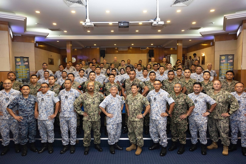 Service members pose for a photo.