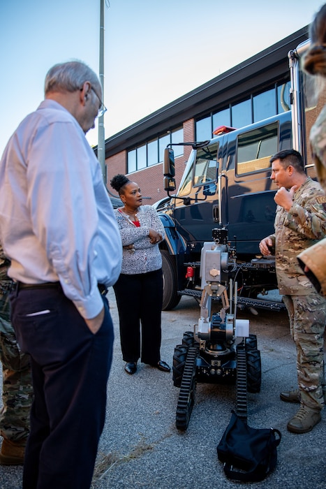 Photo shows people standing around robot